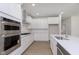 Gourmet kitchen offers stainless steel appliances, modern cabinetry, quartz countertops, and recessed lighting at 5653 Stetson Dr, Whitestown, IN 46052