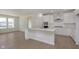 Open kitchen includes stainless appliances, white cabinets and backsplash, island and hard surface floors throughout at 5653 Stetson Dr, Whitestown, IN 46052