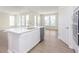 Gourmet kitchen provides stainless steel appliances, white cabinetry, island and durable floors at 5653 Stetson Dr, Whitestown, IN 46052