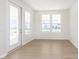 Bright, sunny living room with multiple windows and a glass door to a patio at 5653 Stetson Dr, Whitestown, IN 46052