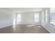 Sunlit room showcases multiple windows, recessed lighting and wood-look flooring, creating a bright and welcoming space at 5653 Stetson Dr, Whitestown, IN 46052