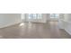 Living room with plentiful natural light and wood-look floors offers ample space for both living and dining at 5653 Stetson Dr, Whitestown, IN 46052