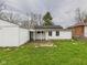 Spacious backyard features a detached garage and a covered patio, great for outdoor living at 612 Woodlawn Dr, Anderson, IN 46012