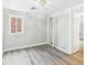 Bedroom with modern flooring, natural light, and an open closet at 612 Woodlawn Dr, Anderson, IN 46012