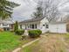 Cozy home featuring tidy landscaping, an attached garage, and a paved driveway leading up to it at 612 Woodlawn Dr, Anderson, IN 46012