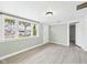 Bright living room with large windows, neutral walls, and modern, light colored flooring at 612 Woodlawn Dr, Anderson, IN 46012