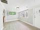 Neutrally painted living room with an accent window, and laminate flooring at 612 Woodlawn Dr, Anderson, IN 46012