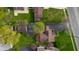 An aerial view showing a house with a vast yard and mature trees in a suburban setting at 6141 Madison Ave, Indianapolis, IN 46227
