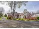 A ranch-style home with brick and siding and a spacious backyard and lovely deck at 6141 Madison Ave, Indianapolis, IN 46227