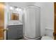 Well-lit bathroom featuring a modern vanity, shower with clear doors, and a toilet at 6141 Madison Ave, Indianapolis, IN 46227