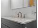 Bathroom vanity featuring gray cabinets, marble countertop, and modern faucet at 6141 Madison Ave, Indianapolis, IN 46227