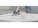 Close-up of bathroom sink featuring a classic chrome faucet and clean, bright white basin at 6141 Madison Ave, Indianapolis, IN 46227