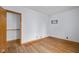 Empty bedroom features hardwood floors and a closet at 6141 Madison Ave, Indianapolis, IN 46227