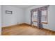 Bedroom featuring hardwood floors and a window with patterned curtains at 6141 Madison Ave, Indianapolis, IN 46227