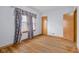 Bedroom featuring hardwood floors and window with patterned curtains at 6141 Madison Ave, Indianapolis, IN 46227