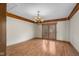 Dining room featuring wood-look vinyl floors, a chandelier, and wood-framed sliding doors at 6141 Madison Ave, Indianapolis, IN 46227