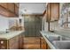 Open kitchen featuring a sink, countertops, wood cabinets, storage pantry, and wood-look vinyl floors at 6141 Madison Ave, Indianapolis, IN 46227