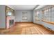 Bright living room with hardwood floors, a brick fireplace, and natural light at 6141 Madison Ave, Indianapolis, IN 46227
