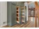 Pantry with built-in sliding wood shelves in a room with wood-look vinyl floors at 6141 Madison Ave, Indianapolis, IN 46227