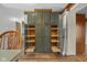 Large, open pantry with sliding shelves and ample storage space next to a dining room at 6141 Madison Ave, Indianapolis, IN 46227