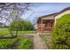 Charming home with brick and wood, a covered porch, and landscape design at 6141 Madison Ave, Indianapolis, IN 46227