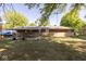 Expansive backyard featuring a covered patio, with a brick and stone facade, perfect for outdoor entertaining at 6144 S Irwin St, Indianapolis, IN 46237