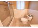 Bathroom with shower, toilet, window, and tiled walls for easy maintenance at 6144 S Irwin St, Indianapolis, IN 46237