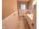 Full bathroom featuring a vanity, toilet, tub/shower combination, and tiled walls at 6144 S Irwin St, Indianapolis, IN 46237