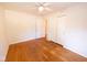 A bedroom with hardwood floors, ceiling fan, closet, and door to another room at 6144 S Irwin St, Indianapolis, IN 46237