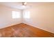 Bedroom featuring hardwood floors, a ceiling fan and two windows at 6144 S Irwin St, Indianapolis, IN 46237