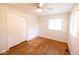 A bedroom with hardwood floors, ceiling fan, closet, and a window at 6144 S Irwin St, Indianapolis, IN 46237
