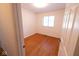A bright bedroom featuring hardwood floors and a window providing natural light at 6144 S Irwin St, Indianapolis, IN 46237