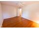 A bedroom with hardwood floors, ceiling fan, closet, and door to another room at 6144 S Irwin St, Indianapolis, IN 46237