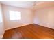A bedroom with hardwood floors, ceiling fan, closet, and a sunlit window at 6144 S Irwin St, Indianapolis, IN 46237