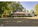 Traditional home featuring a lush front lawn, complemented by a shed, and charming brick and stone accents at 6144 S Irwin St, Indianapolis, IN 46237