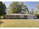 Charming single-story home featuring a brick facade, well-manicured lawn, and attached two-car garage at 6144 S Irwin St, Indianapolis, IN 46237
