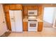 Functional kitchen with wooden cabinetry, and modern white appliances at 6144 S Irwin St, Indianapolis, IN 46237