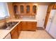 A kitchen showcasing ample counter space, a double sink, wooden cabinetry, and modern appliances at 6144 S Irwin St, Indianapolis, IN 46237