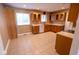 Well-lit kitchen featuring wooden cabinetry, tile floors, and modern appliances at 6144 S Irwin St, Indianapolis, IN 46237