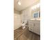 Well-lit bathroom featuring a shower-tub combo, large vanity, and tile-look flooring at 6222 Fairview Dr, McCordsville, IN 46055