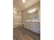 Clean bathroom showcasing a shower-tub combo, toilet, large vanity, and wood-look flooring at 6222 Fairview Dr, McCordsville, IN 46055