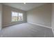 Cozy bedroom with plush carpeting, fresh paint, and a large window offering plenty of natural light at 6222 Fairview Dr, McCordsville, IN 46055
