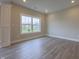 Inviting bedroom with hardwood floors and a large window showcasing the outdoor view at 6222 Fairview Dr, McCordsville, IN 46055