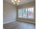 Bright dining room with wood floors, chandelier lighting, and large window with neighborhood view at 6222 Fairview Dr, McCordsville, IN 46055