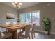 Bright dining room features a chandelier, a wood table with seating for six, and a large window at 6222 Fairview Dr, McCordsville, IN 46055