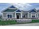 Charming home exterior with stone accents, blue shingles, and a well-manicured lawn at 6222 Fairview Dr, McCordsville, IN 46055