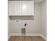 Clean laundry room with storage cabinets, washer/dryer hookups, and tile-look flooring at 6222 Fairview Dr, McCordsville, IN 46055