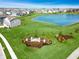 Panoramic aerial shot features homes and lush landscaping around a lake near the community entrance sign at 6767 Sonora Blvd, Brownsburg, IN 46112