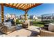Landscaped backyard with a seating area, wood pergola, and a trampoline for outdoor enjoyment at 6767 Sonora Blvd, Brownsburg, IN 46112