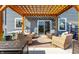 Backyard patio under a wood pergola, with comfortable chairs, string lights, and lush greenery at 6767 Sonora Blvd, Brownsburg, IN 46112